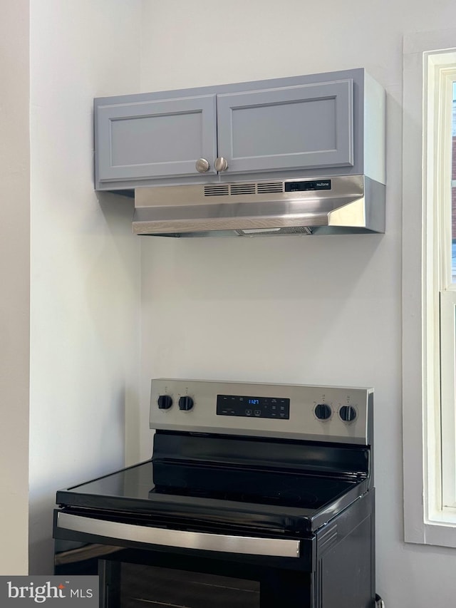 kitchen with gray cabinets and stainless steel electric range