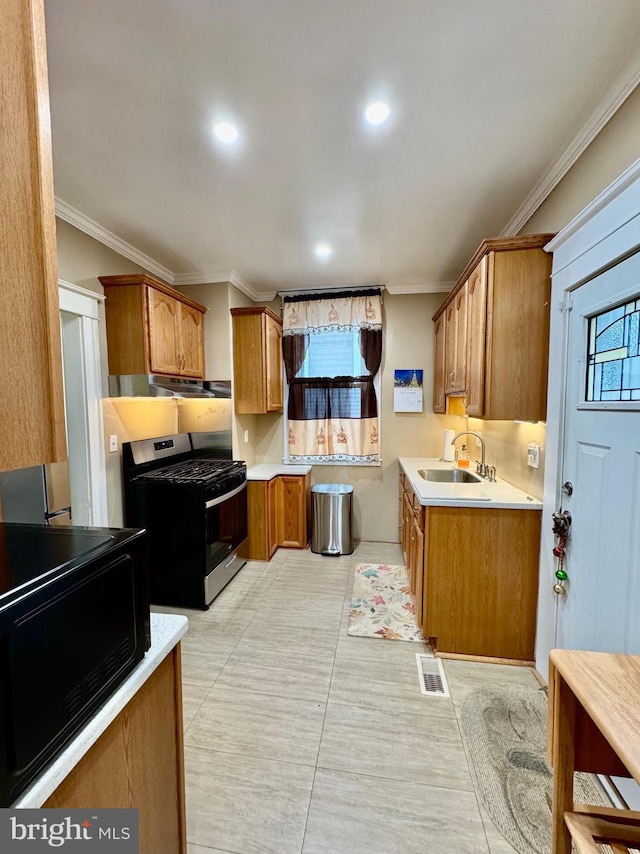 kitchen featuring ornamental molding, sink, light tile patterned floors, and stainless steel range with gas stovetop