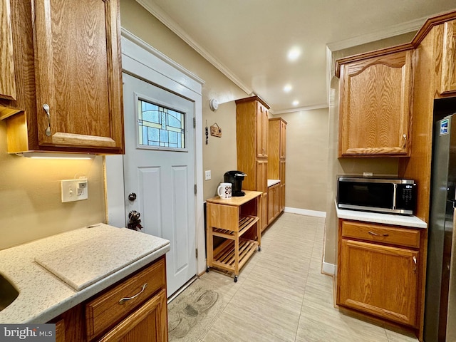 kitchen with stainless steel appliances and ornamental molding