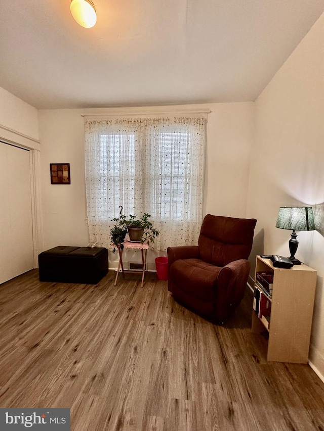 sitting room with hardwood / wood-style flooring