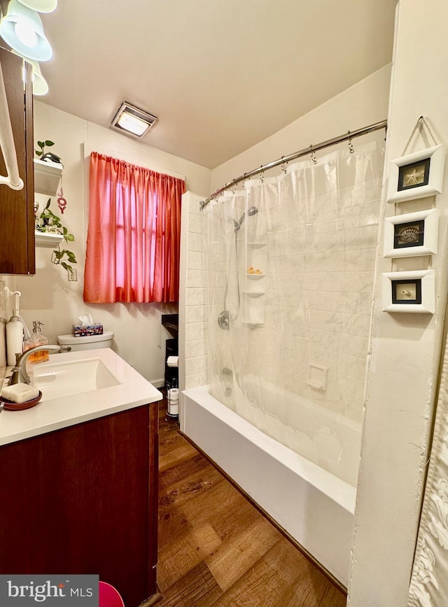 bathroom featuring hardwood / wood-style floors, vanity, and shower / bathtub combination with curtain