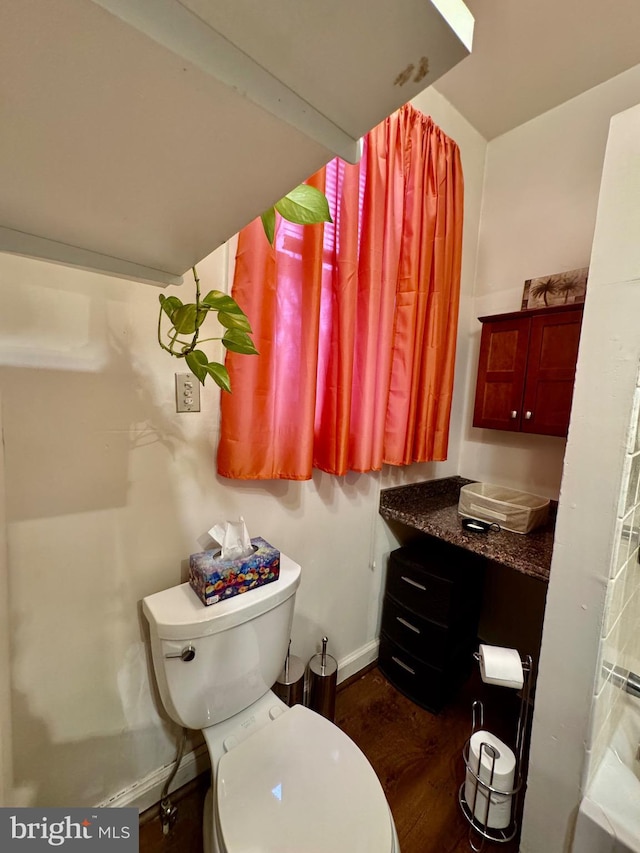 bathroom with wood-type flooring and toilet