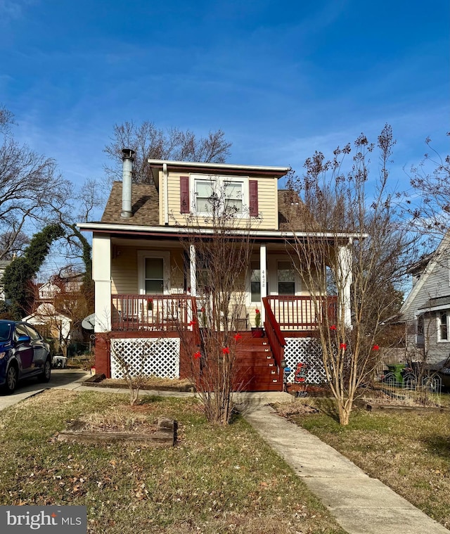 view of front facade with covered porch and a front lawn