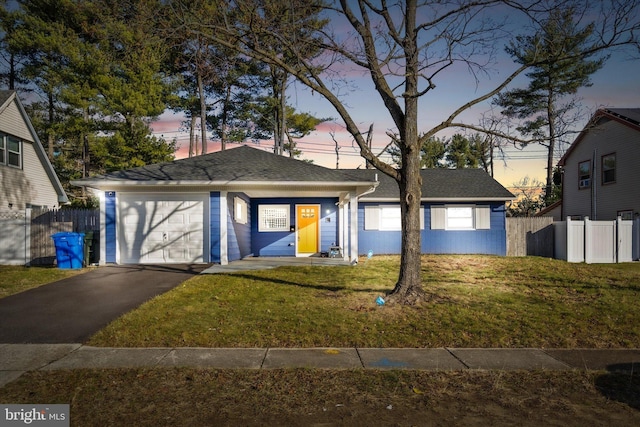 view of front facade with a lawn and a garage