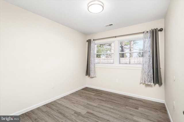 spare room with wood-type flooring