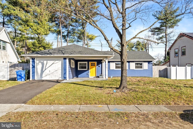 view of front of house featuring a garage, covered porch, and a front lawn