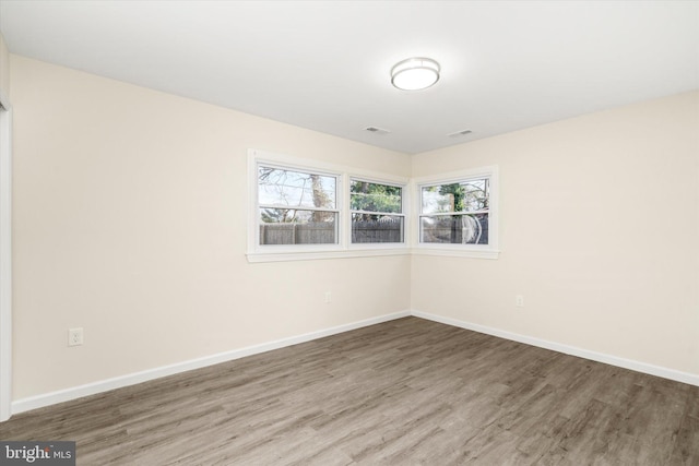 empty room with wood-type flooring