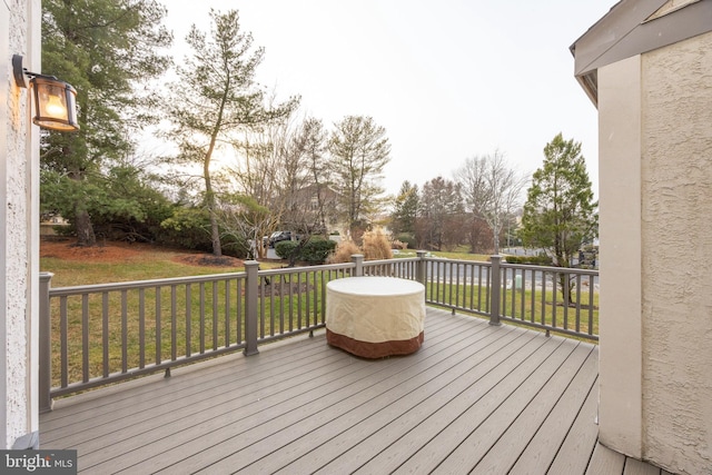 wooden deck with a lawn