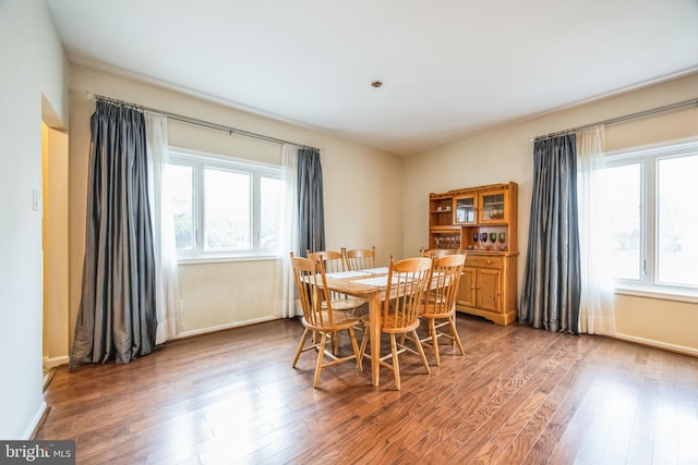 dining space with hardwood / wood-style floors and plenty of natural light