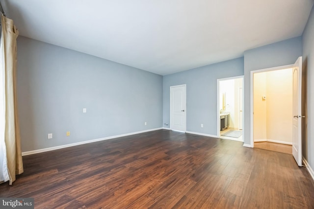 spare room featuring dark wood-type flooring