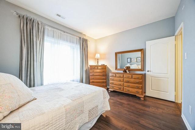 bedroom with dark wood-type flooring