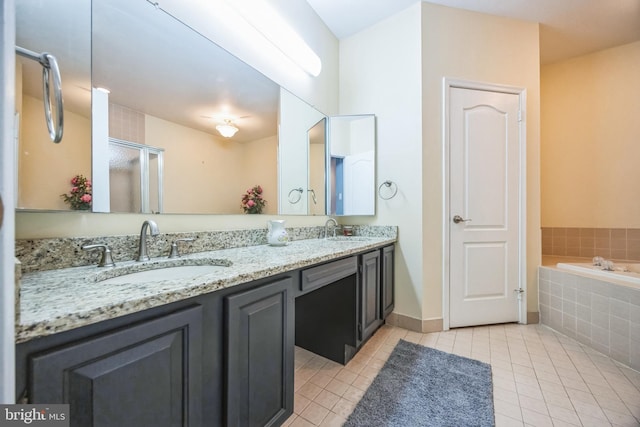 bathroom featuring separate shower and tub, vanity, and tile patterned floors