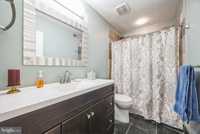 bathroom with toilet and vanity