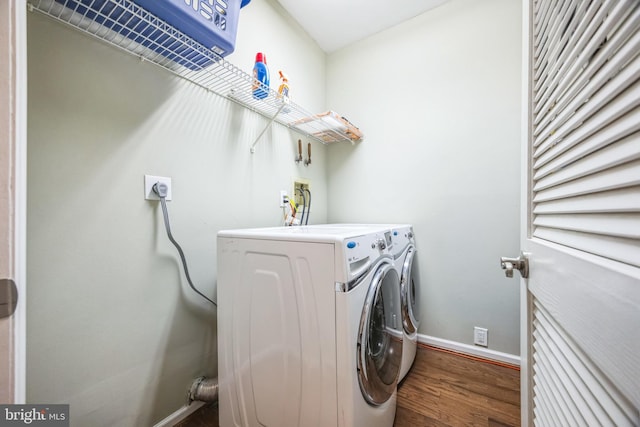 laundry area with wood-type flooring and separate washer and dryer