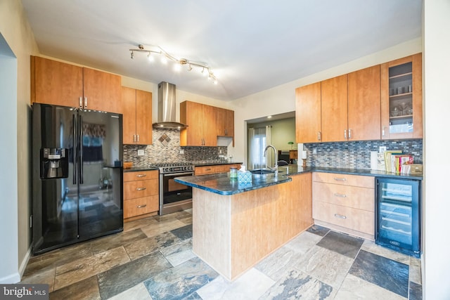 kitchen featuring kitchen peninsula, gas stove, black fridge with ice dispenser, wine cooler, and wall chimney range hood