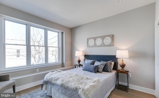 bedroom with hardwood / wood-style flooring