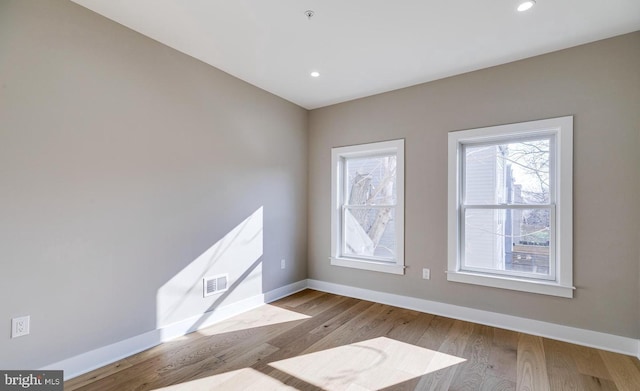 spare room featuring light hardwood / wood-style floors