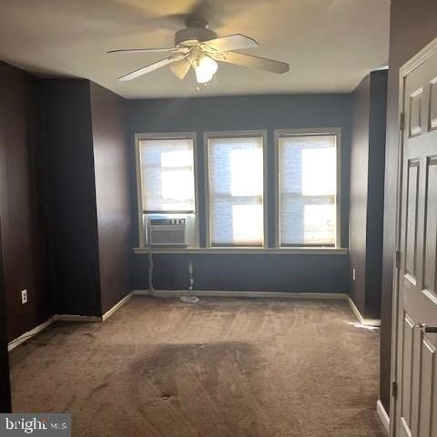 carpeted empty room featuring ceiling fan and cooling unit