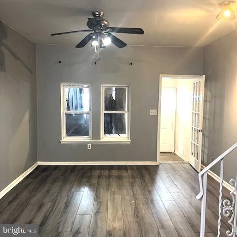 spare room featuring dark hardwood / wood-style floors and ceiling fan