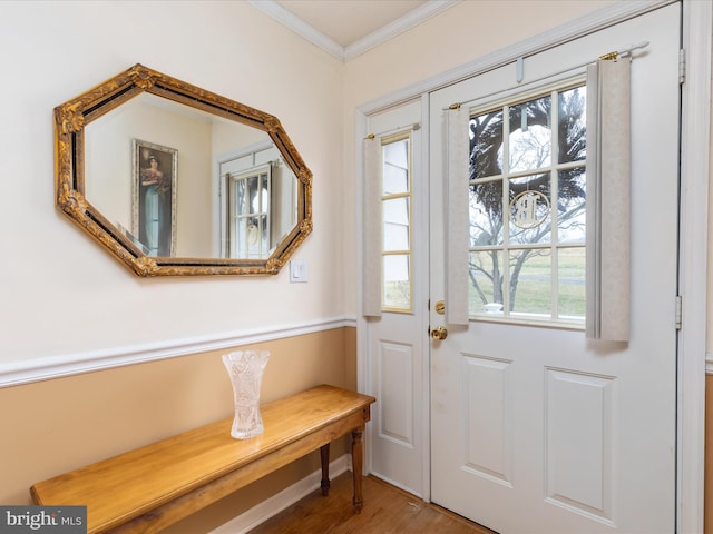 entryway featuring hardwood / wood-style flooring and crown molding