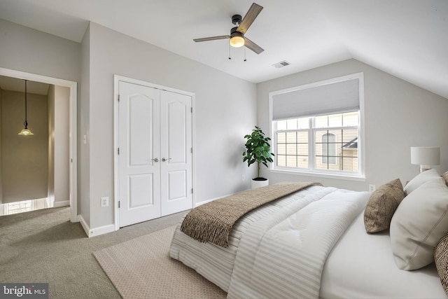 carpeted bedroom with a closet, ceiling fan, and lofted ceiling