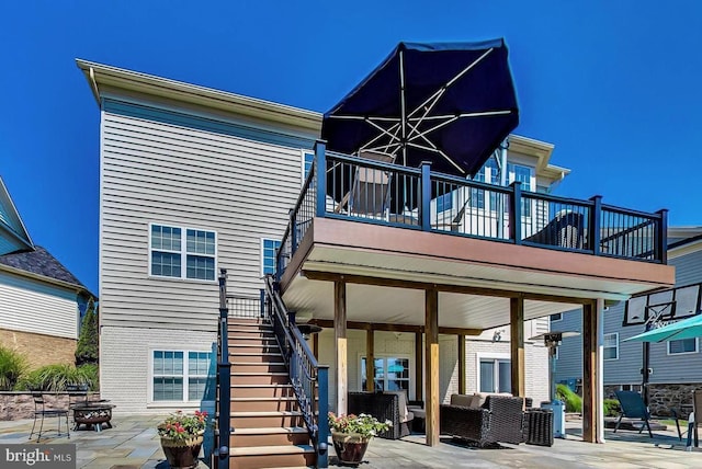 rear view of property featuring an outdoor living space and a patio