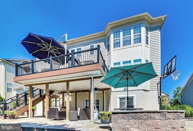 back of house featuring a patio area and a wooden deck