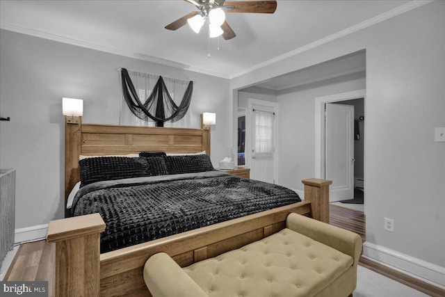 bedroom featuring ornamental molding, hardwood / wood-style floors, and ceiling fan