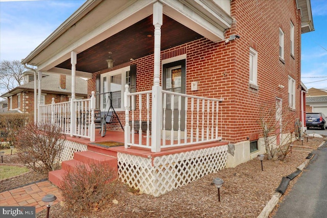 view of side of home with a porch