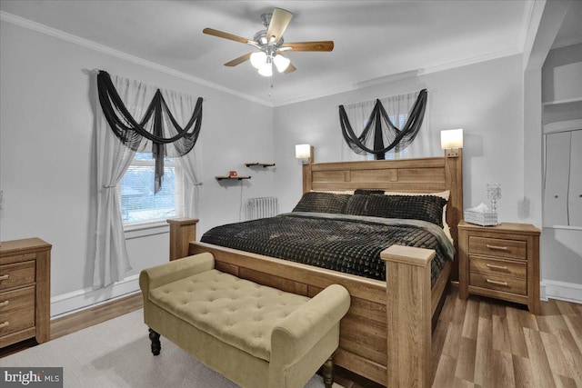 bedroom with ceiling fan, ornamental molding, and light hardwood / wood-style floors