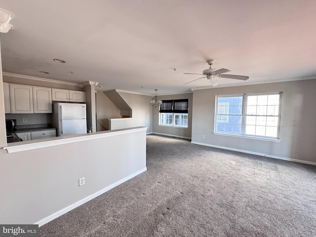 kitchen with carpet, white fridge, ceiling fan with notable chandelier, and ornamental molding