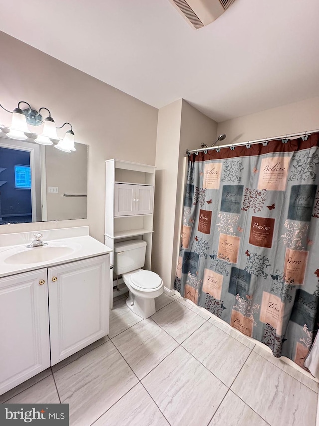 bathroom with vanity, toilet, and curtained shower