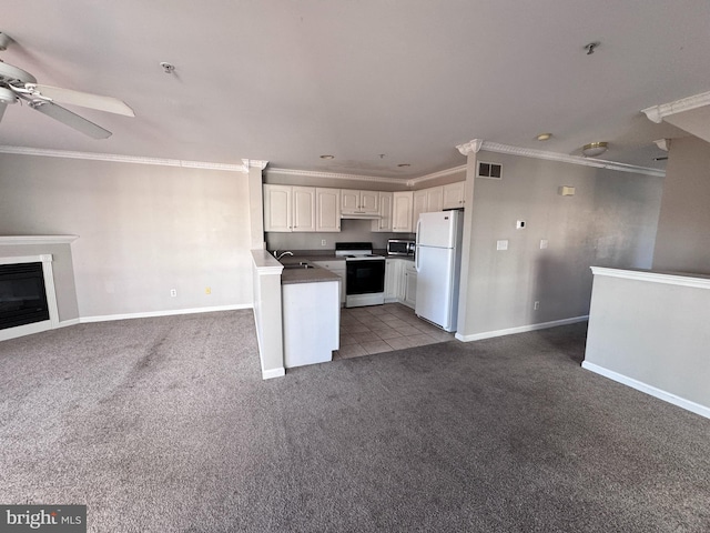 kitchen featuring white cabinetry, sink, kitchen peninsula, white appliances, and carpet