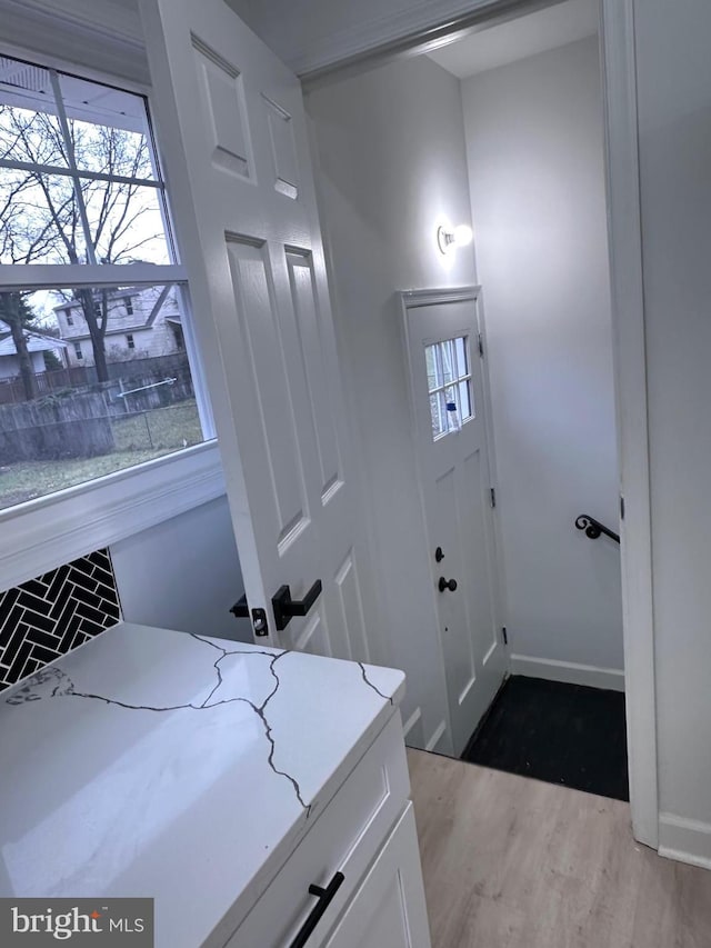 laundry area with light hardwood / wood-style flooring