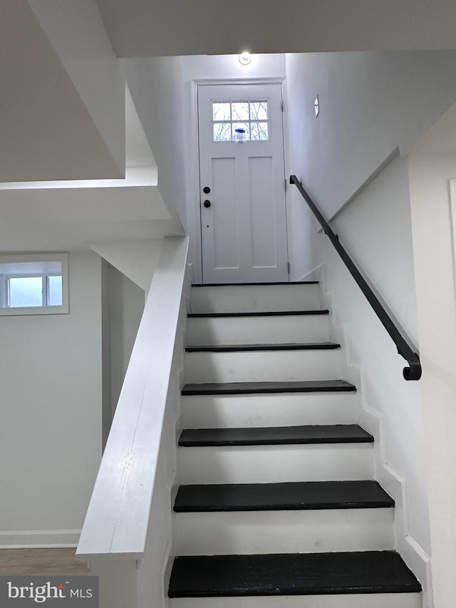 stairs featuring hardwood / wood-style floors