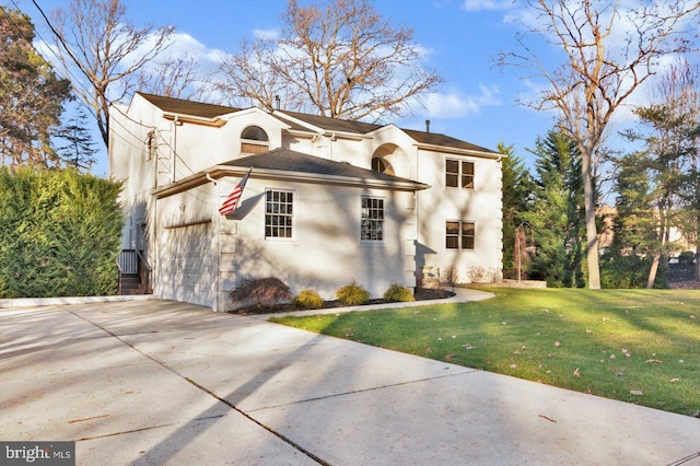 view of front of house featuring a garage and a front lawn