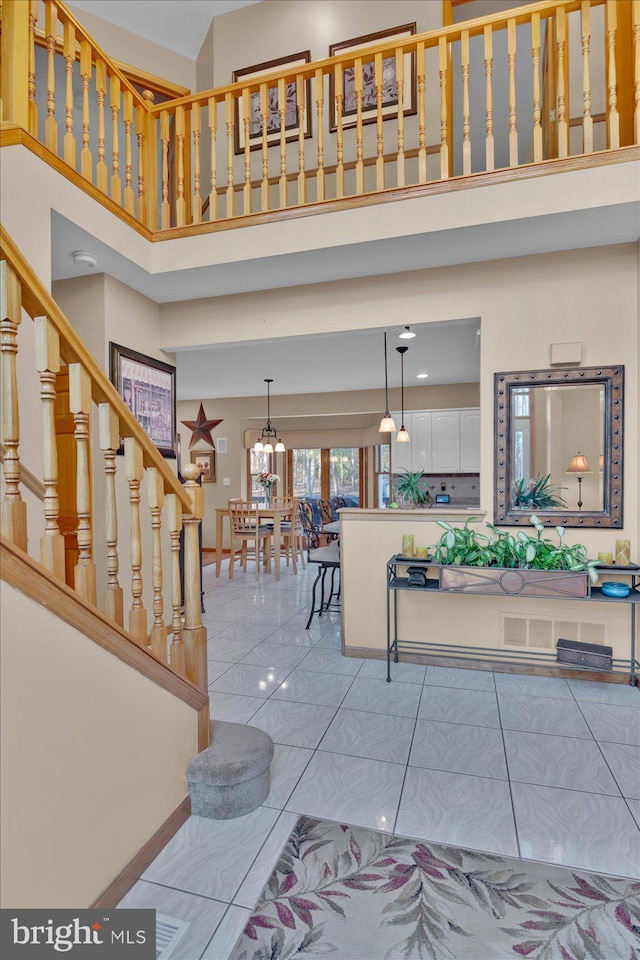 foyer featuring a high ceiling and a notable chandelier