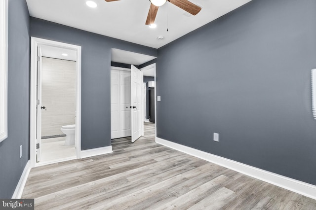 unfurnished bedroom with a closet, ensuite bathroom, ceiling fan, and light hardwood / wood-style floors