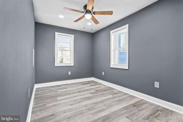 unfurnished room with ceiling fan and light wood-type flooring