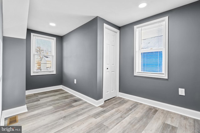 empty room with light hardwood / wood-style floors