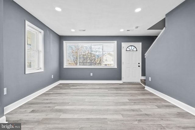 foyer entrance with light hardwood / wood-style flooring