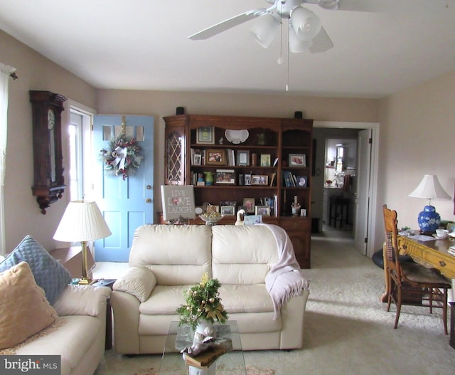 carpeted living room featuring ceiling fan