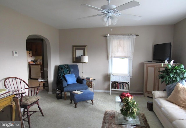 carpeted living room with ceiling fan