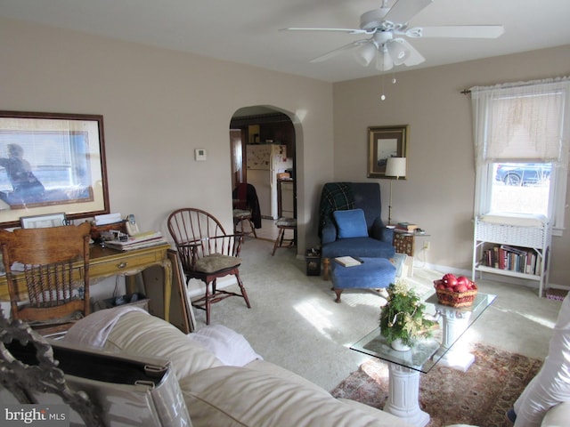 carpeted living room with ceiling fan