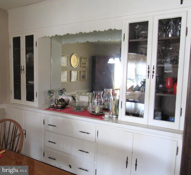 bar featuring white cabinets