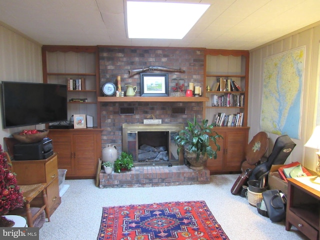 living room with a fireplace, light carpet, and built in features