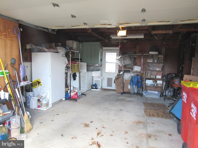 garage with washing machine and dryer and a garage door opener