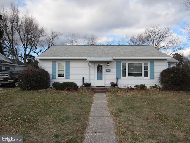 ranch-style home with a front lawn