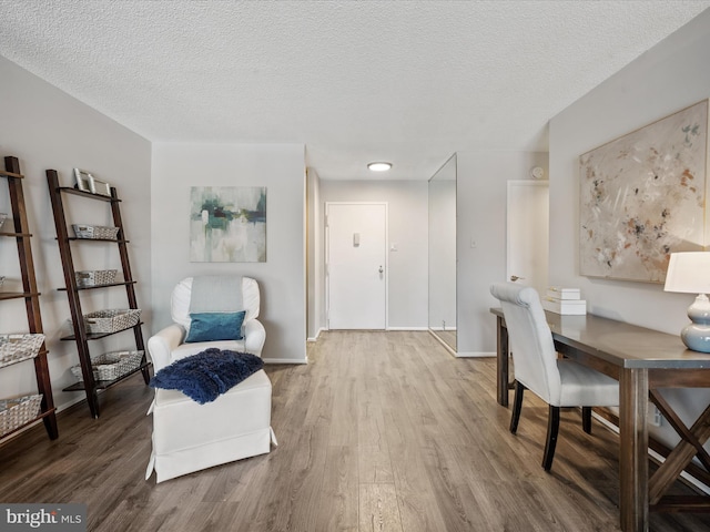 interior space with a textured ceiling and wood-type flooring