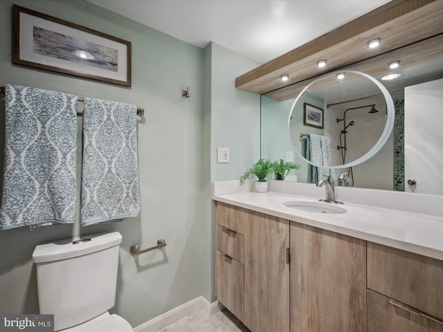 bathroom with walk in shower, vanity, and toilet